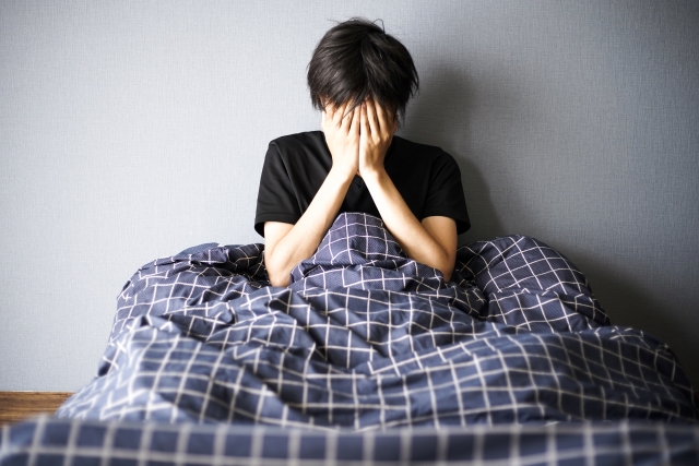 眠れなくて頭を抱える男性 | 脳活整体ルーム APLO（アプロ）